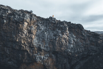 Professional mountain climber posing at the peak of mountain