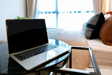 Fototapeta premium notebook computer set on the table in front of the sofa