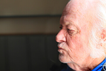 old man age 70 close up sitting inside a pub