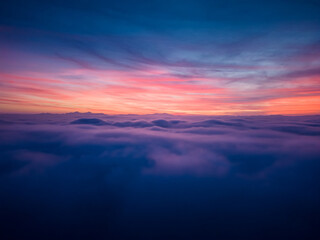 aerial view above the clouds at sunset