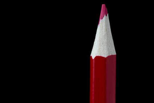 close up of red crayon on black background 