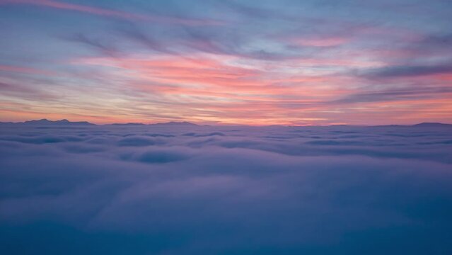aerial hyperlapse above the clouds at sunset. the video transmits peace and silence wishing a happy new year 2023