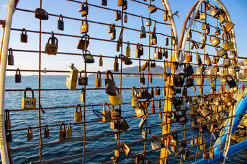Lovers and padlocks. Locks suspended from the bridge bar