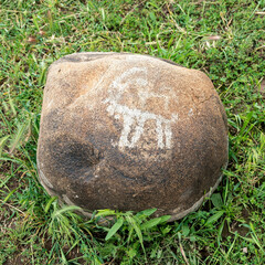 Petroglyph in Kyrgyzstan. An ancient rock carving and engraving known as petroglyphs created by...