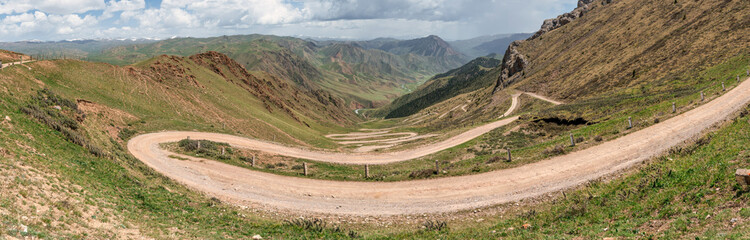 33 parrots, a zig zag serpentine road climbing up to Song Kul Lake, a high alpine lake in the Tian...