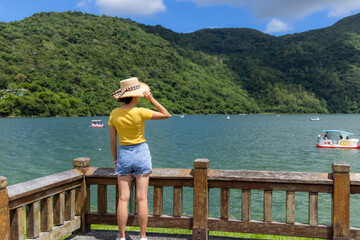 Woman look at the lake water pond view at summer time