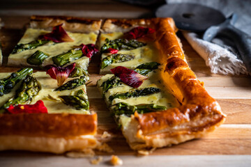 Asparagus tart with a ricotta/egg/dill base on puff pastry,  garnished with nasturtium petals