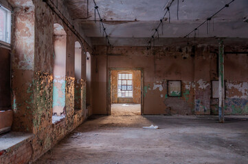Fototapeta na wymiar Old abandoned haunted red brick factory of stockings, pantyhose and socks in Central Europe, Poland
