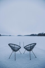 Chairs in front of a frozen lake