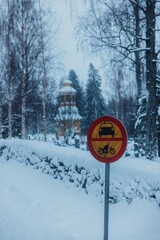 sign in snow with church in background