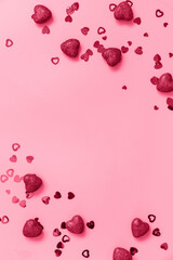 Valentines, love and wedding concept ideas. Frame red hearts on pink background. Flat lay, top view. Trendy color of year 2023 - Viva Magenta.