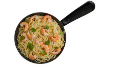 Spaghetti with shrimps in a frying pan isolated on white background
