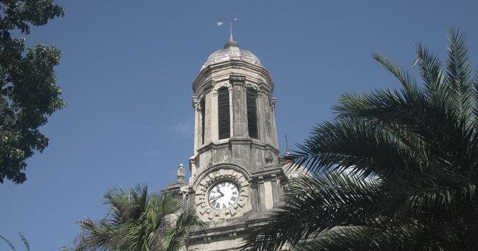 Antigua Caribbean palm trees St Johns Cathedral clock tower. Church of Diocese North Eastern Caribbean and Aruba. Anglican Church of England. Originally built 1683. Seventy foot twin towers.