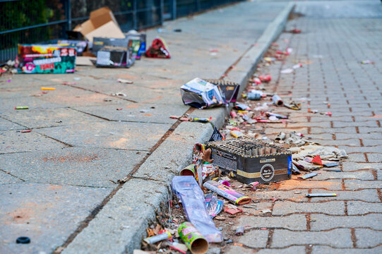 Berlin, Germany - January 1, 2023: Various remains of a New Year's Eve celebration along a street.