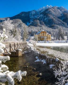 A sunny winter morning at a snowy and iced Lake Dobbiaco, Province of Bolzano, Trentino Alto Adige, Italy.