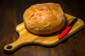 Traditional round loaf of bread on a wooden table