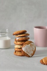 cookies for valentine's day and pink cup of coffee. Round cookie with a glazed heart in the center. Oatmeal cookies with icing. Food for Valentine's Day 