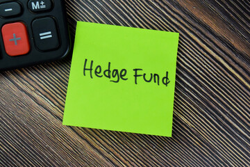 Concept of Hedge Fund write on sticky notes isolated on Wooden Table.