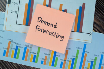Concept of Demand Forecasting write on sticky notes isolated on Wooden Table.