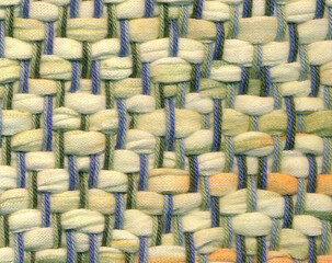 Closeup of handwoven rag rug in pastel colors