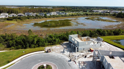 Aerial drone image of Florida neighborhood by lake with new construction development