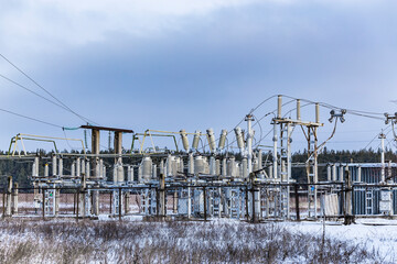 High voltage vintage electrical substation in Ukraine in winter. Wiring, connections and insulators. Russian missile attacks on Ukrainian energy during war. Shutdown. Power plant.