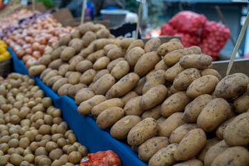 Yellow potatoes and price tag on the bazaar.
