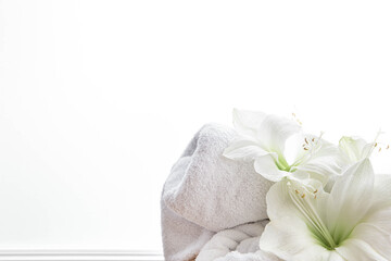 Fototapeta na wymiar Close-up, lily flowers and a towel on a white background isolated.