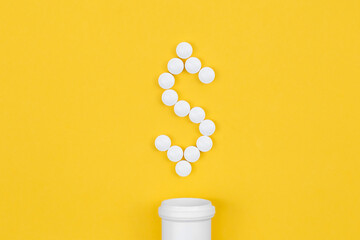 Tablets laid out in the shape of a dollar, conceptual minimalism.