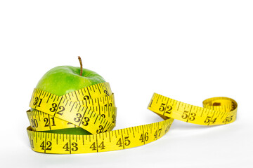 Green apple and meter on a white background isolated.