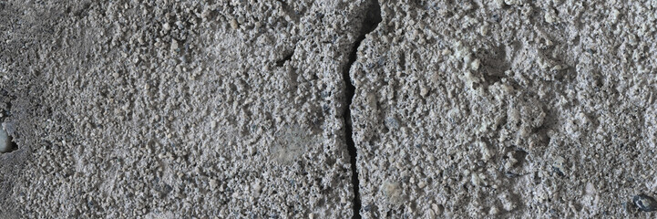 Texture of old cracked concrete wall. Rough gray concrete surface. Wide panoramic background for design.