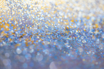 Abstract soft light blur blink sparkle defocus backgound. Gold and blue glitters glow shine dots...