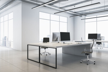 Perspective view on stylish workspace table with modern computers on glossy ceramic tiles floor in coworking office with light wall background and city view from big windows. 3D rendering - obrazy, fototapety, plakaty