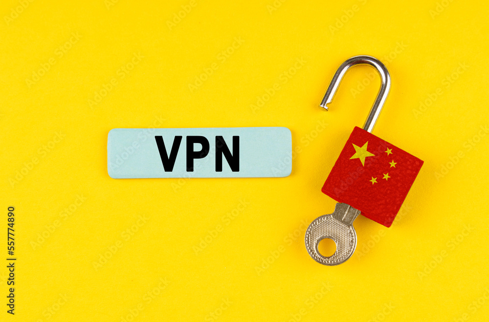 Poster on the yellow surface is an open lock with a key and a sticker with the inscription - vpn