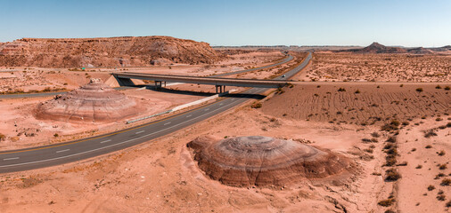 Northern Arizona highway through red rocks and landscape. Beautiful road trip through America near Monument Valley.