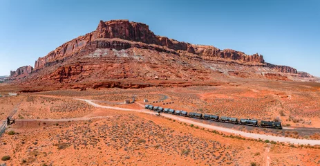 Gordijnen Page, Arizona. September 07, 2022. Aerial view of the cargo locomotive railroad engine crossing Arizona desert wilderness. Logistics transportation across America. © ingusk