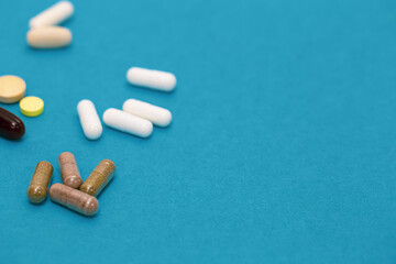 Pills on a blue background, close-up, medicine concept.