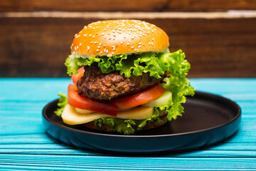 Burger served on black plate