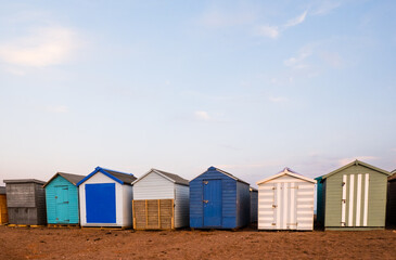 Fototapeta na wymiar Beach Huts On Teignmouth's Back Beach At Sunset