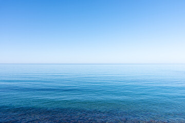 Ocean sky horizon line blends into infinity with blue turquoise colors of ocean waters and...