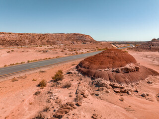 Northern Arizona highway through red rocks and landscape. Beautiful road trip through America near Monument Valley.