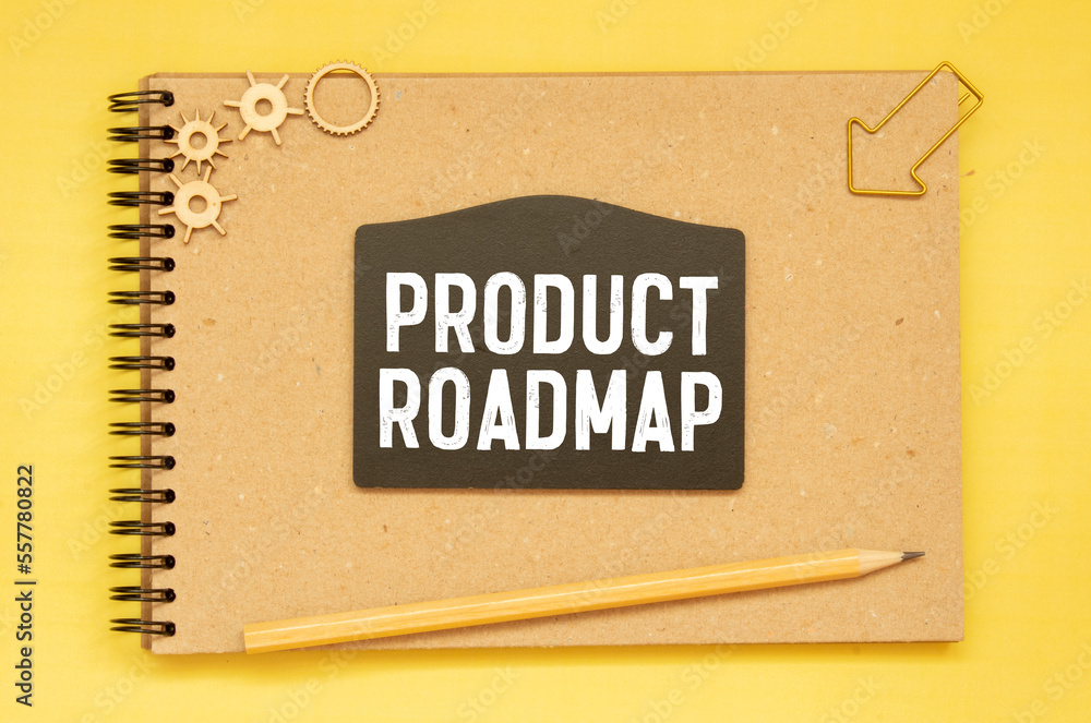 Poster education concept.text product roadmap writing on notepaper with pen and calculator on blue backgrou