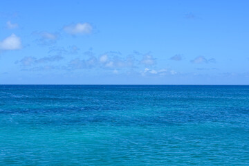 Azure Caribbean sea meets blue sky. Space for copy.	