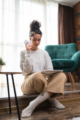 Obraz premium One woman shopping online hold credit card and digital tablet at home