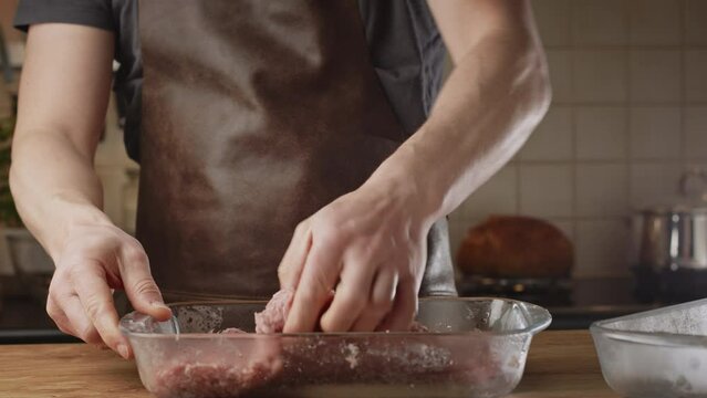 Home chef preparing a BBQ recipe - the Balkan kebapche or cevapcici. Closeup shot. Low angle.