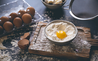 Flour, butter and eggs on the kitchen table, close-up.