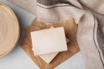 Compressed and granulated yeast on light gray table, flat lay