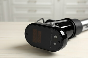 Thermal immersion circulator on white table in kitchen, closeup with space for text. Sous vide...
