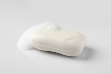 Obraz na płótnie Canvas Soap with fluffy foam on white background