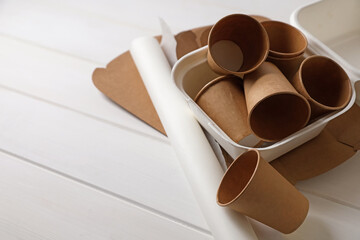 Heap of waste paper on white wooden table, space for text